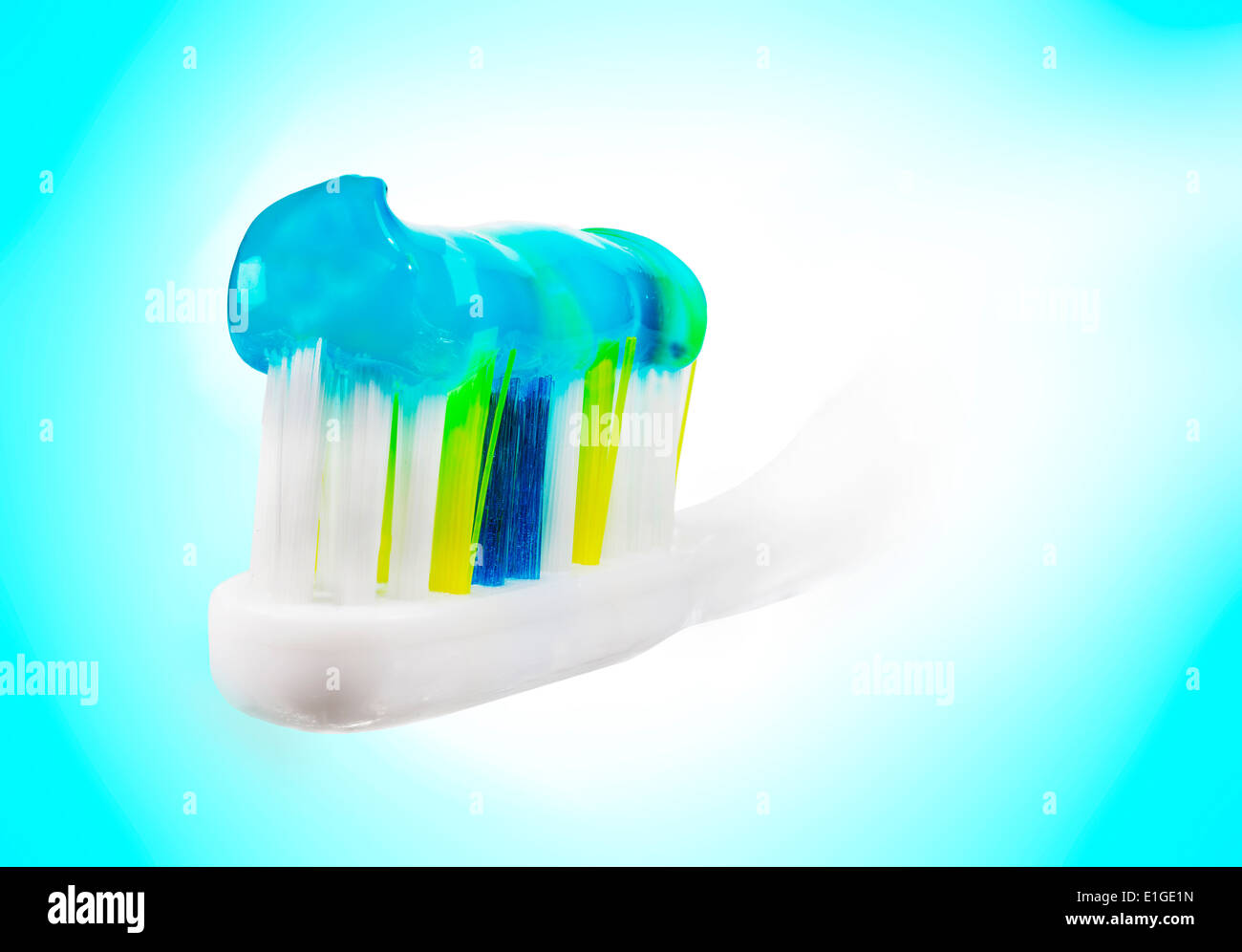 Tooth brush with paste on blue and white background. Stock Photo