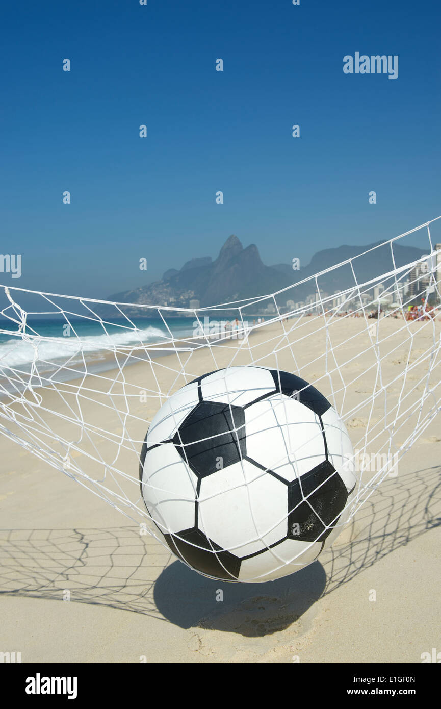 Soccer ball relaxing in football goal net hammock on Ipanema Beach in