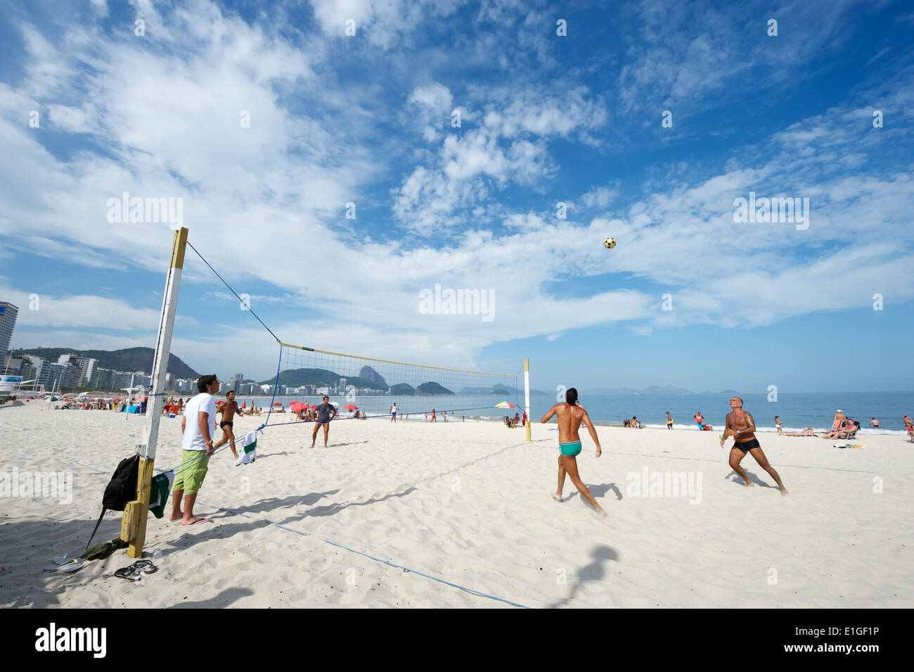 RIO DE JANEIRO, BRAZIL - CIRCA JANUARY, 2011: Young Brazilian men play a game of footvolley, a sport that combines football and Stock Photo
