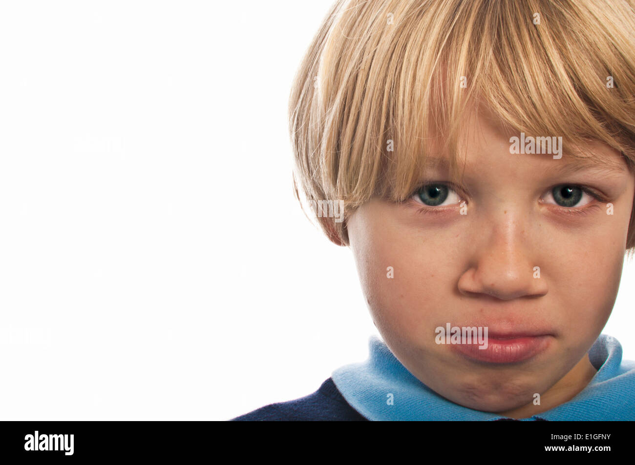 boy isolated against white with a sad face Stock Photo