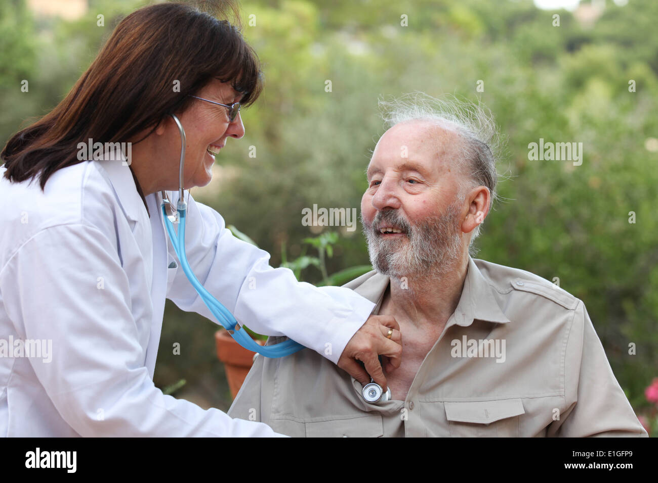dr with stethoscope checking senior patients heart beat Stock Photo - Alamy