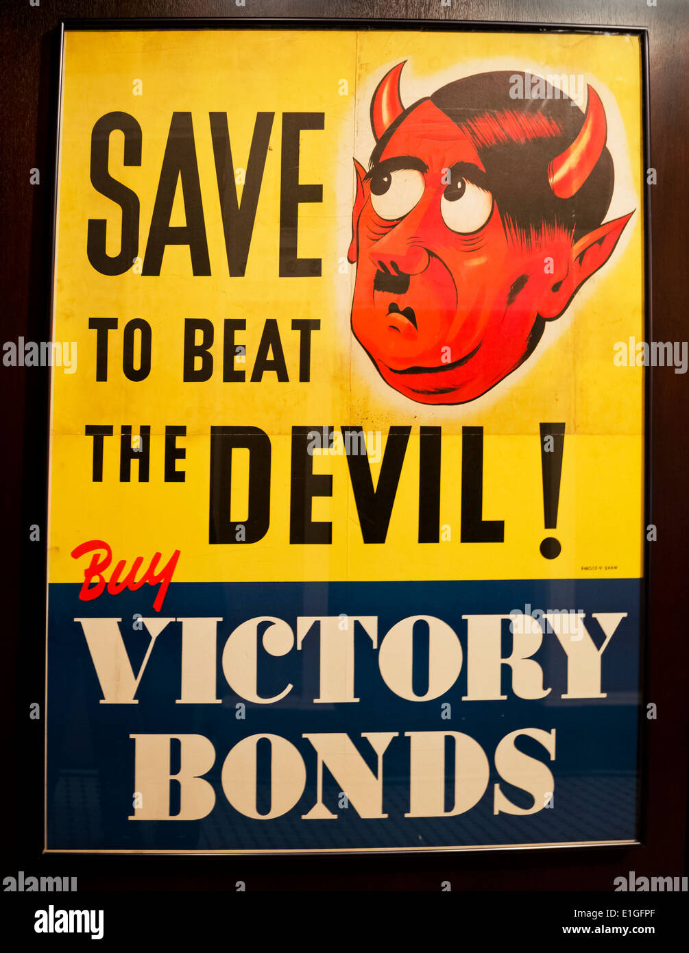 Canadian World War II poster:  'Save to Beat the Devil:  Buy Victory Bonds'. Featuring Hitler as the devil. Stock Photo