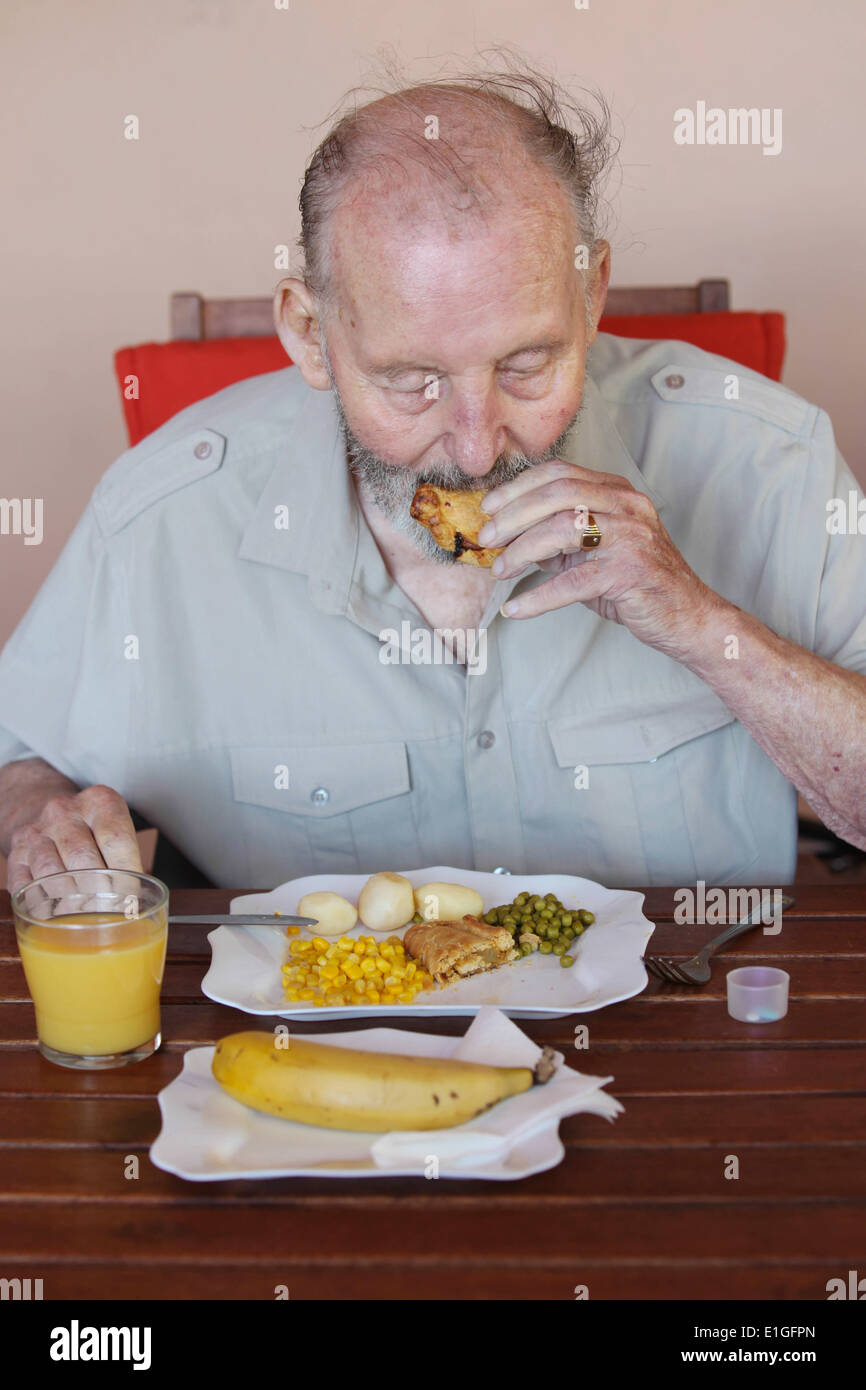 elderly man eating healthy lunch in care home Stock Photo