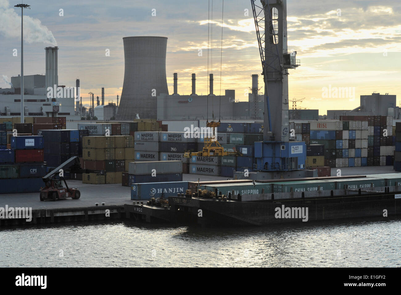 Container shipment with crane and reach stacker at the harbour Moerdijk, 20 July 2012 Stock Photo