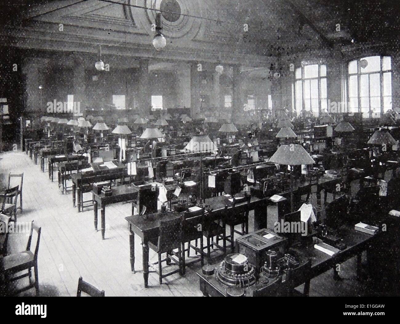 Photograph taken of a telegraphic operating room at the General Post Office in London. The number of telegraphic messages transmitted from the various London offices in the years 1895-96 was 27,025,193, and the total for the United Kingdom, 78,839,610. As many as six messages-three in each direction- are now transmitted along a single wire at the same time. Dated 1896, London Stock Photo