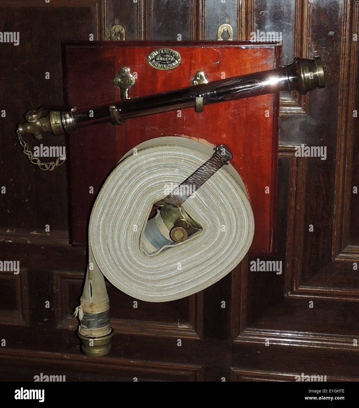 19th century fire hose on a wall at Warwick Castle Stock Photo