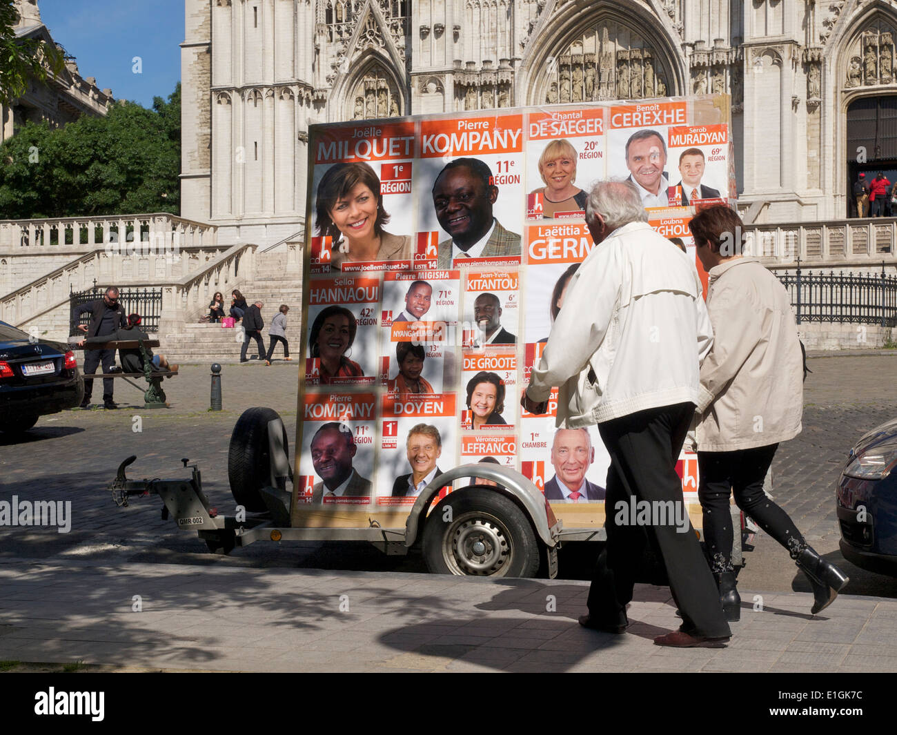 Older couple walking past European election posters in the city center of Brussels, Belgium Stock Photo