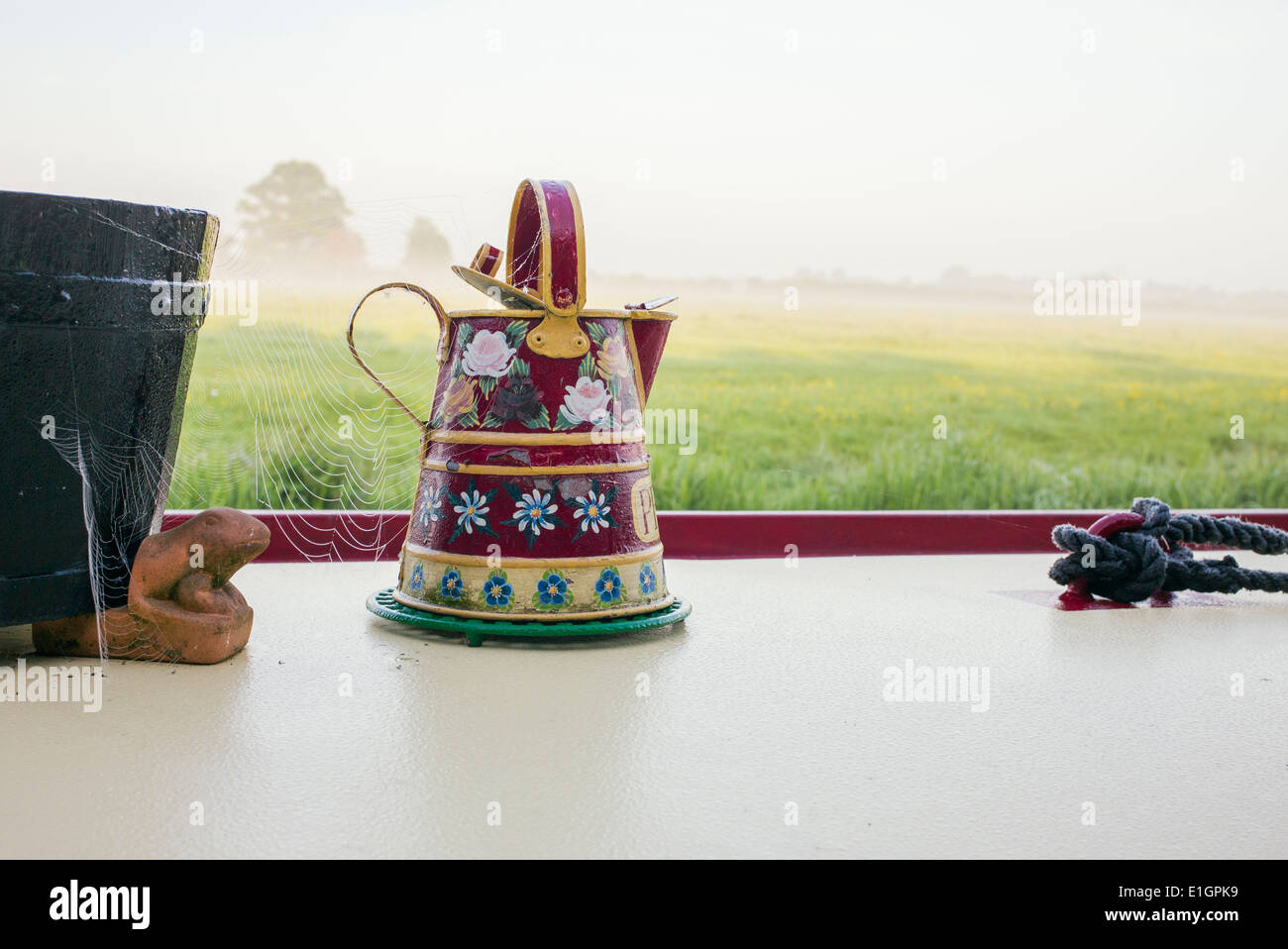 Canal Folk Art on metal jug on the roof of a narrowboat Stock Photo