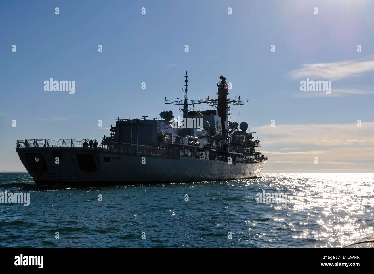 F239, Royal Navy Type 23 Frigate, HMS Richmond at sea sailing towards the sun Stock Photo