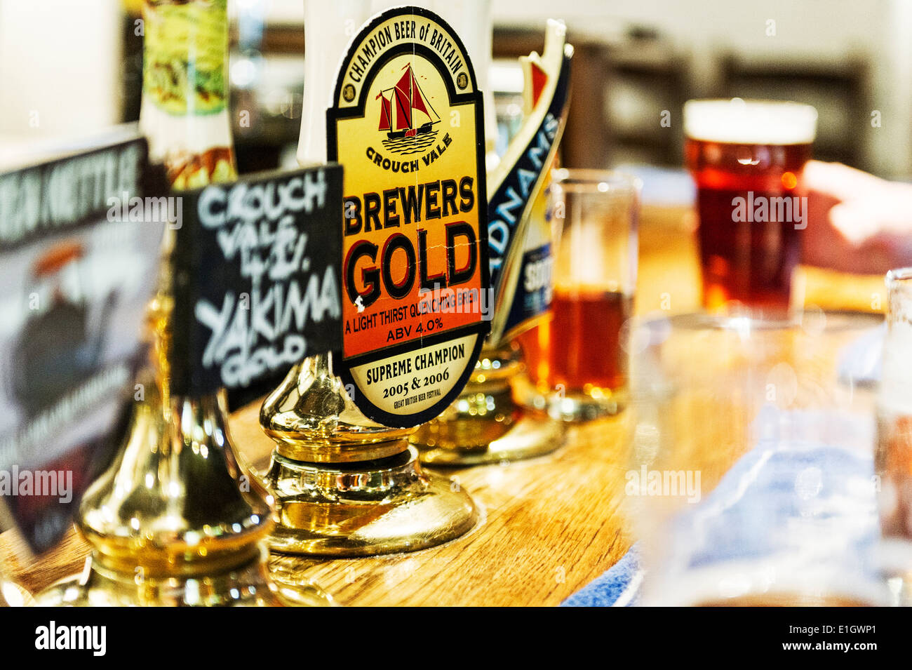 Real Ale beer pump handles on a bar. Stock Photo