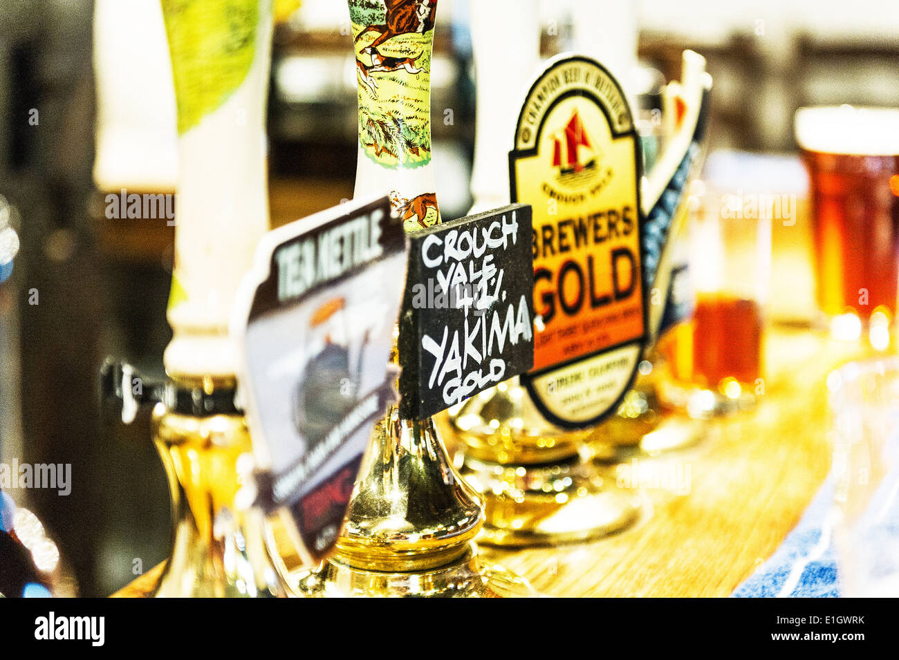 Beer pump handles on a bar in a pub. Stock Photo
