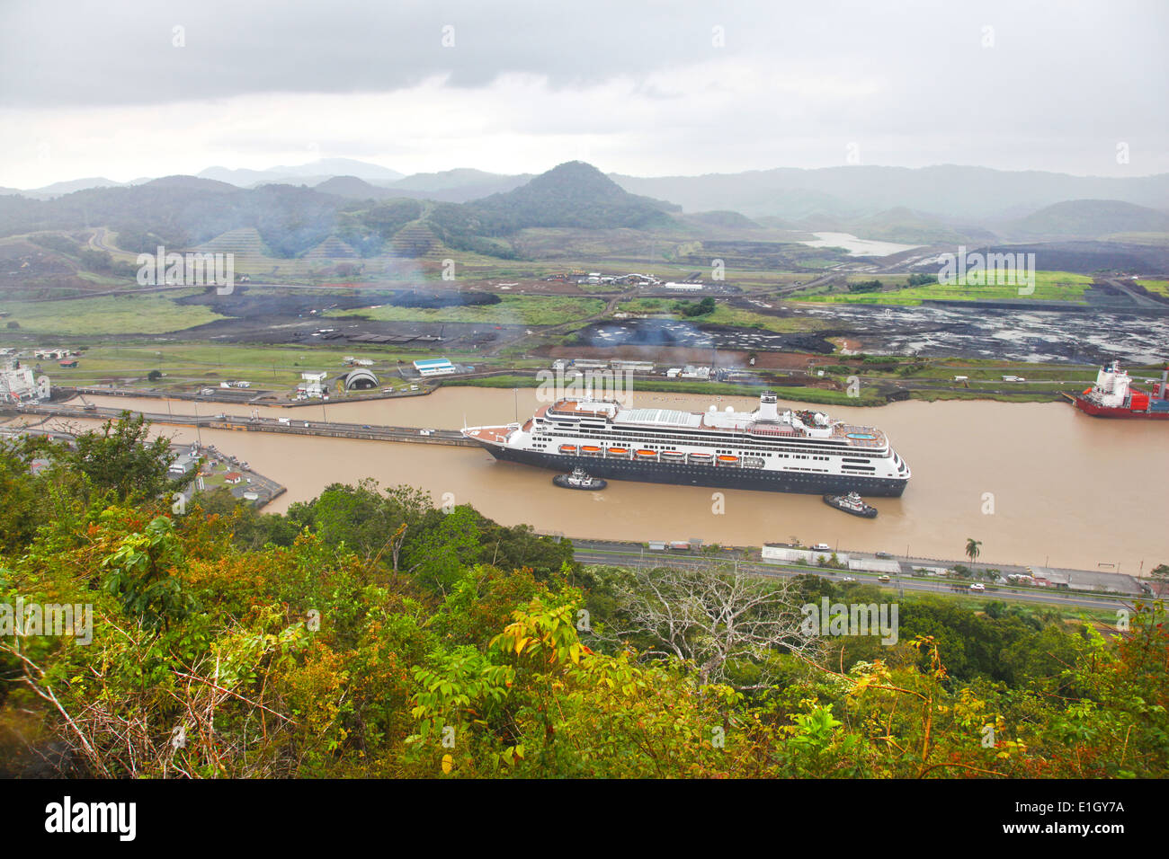 Cruise ship enters the Pedro Miguel lock with construction of the new canal in the background, Panama, Central America. Stock Photo