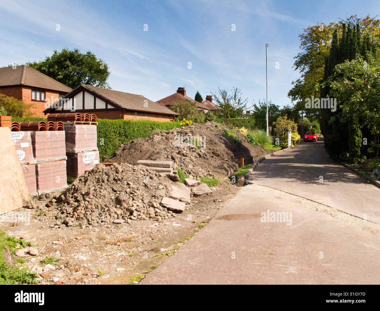 self building house, building materials and piles of spoil soil on site Stock Photo