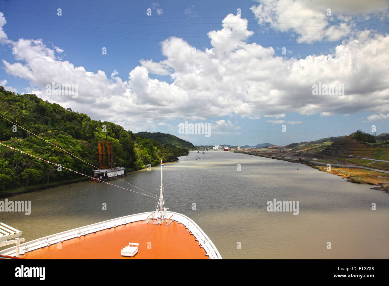 Cruise ship transits Culebra Cut, formerly called Gaillard Cut on a beautiful day with Pedro Miguel lock ahead, Panama canal. Stock Photo
