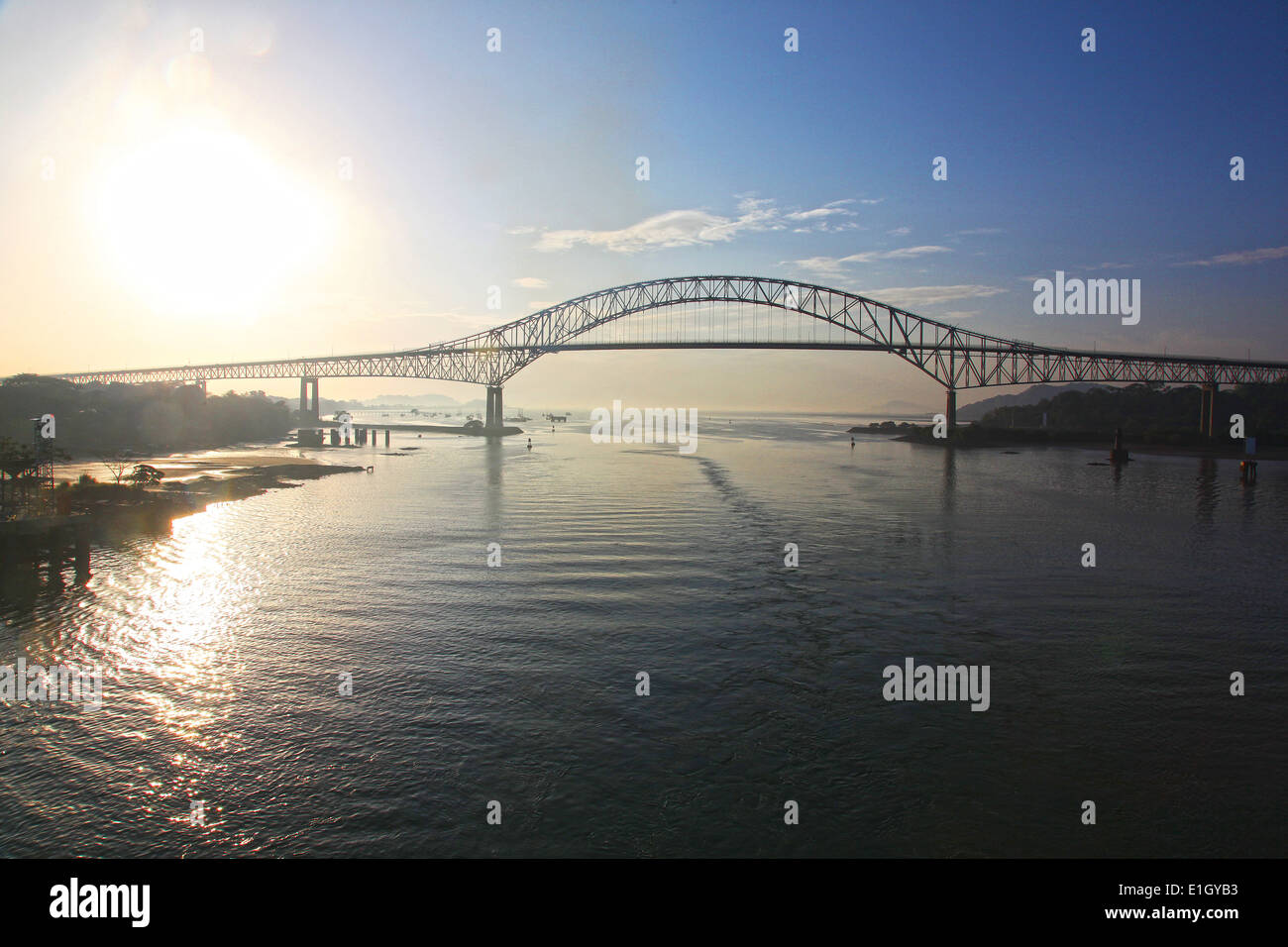 Sunrise behind the Bridge of the Americas, across the Panama Canal, Panama, Central America. Stock Photo