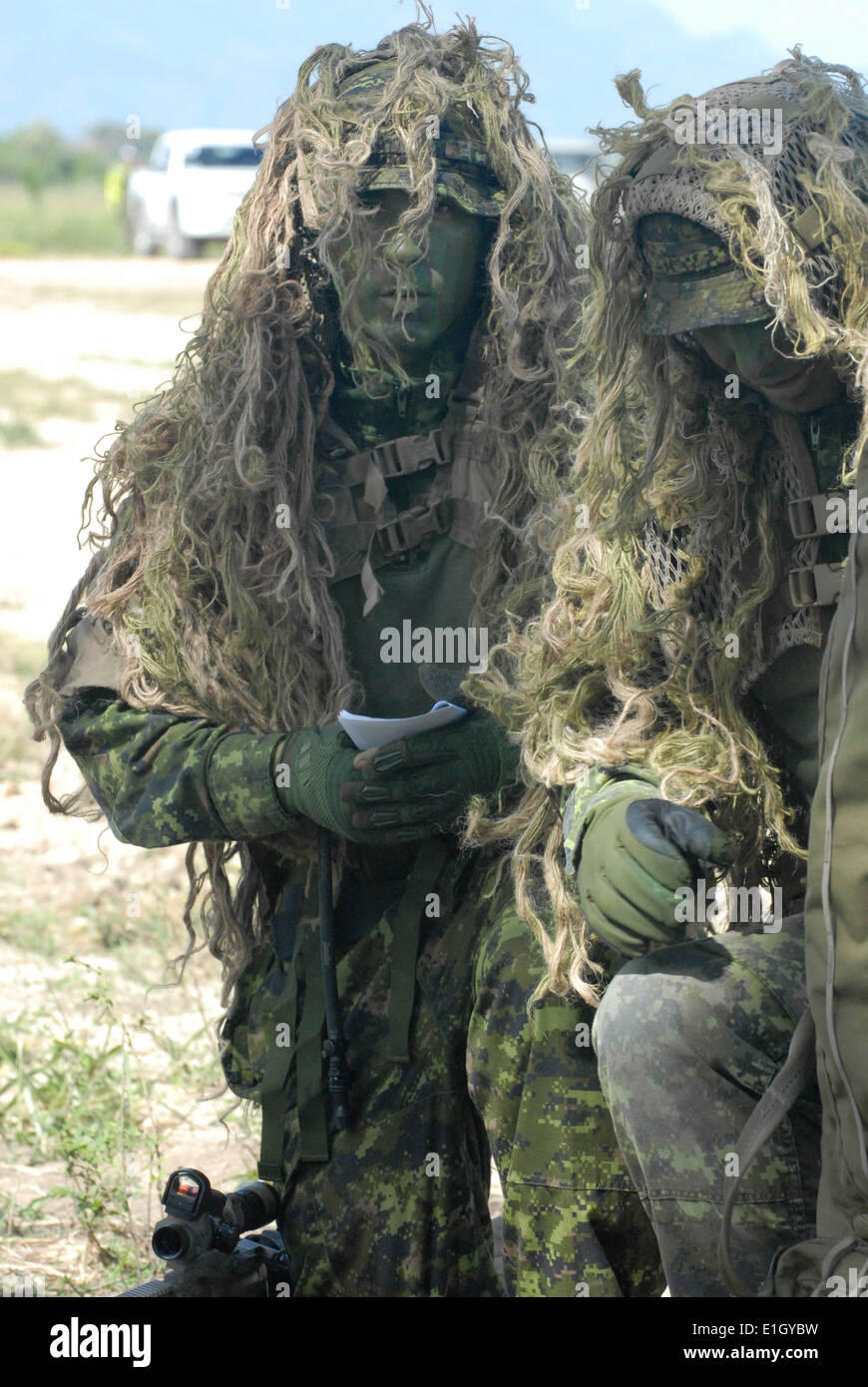 Canadian special operations forces snipers plan an entry strategy into the sniper stalk event field June 9, 2012, at the Colomb Stock Photo