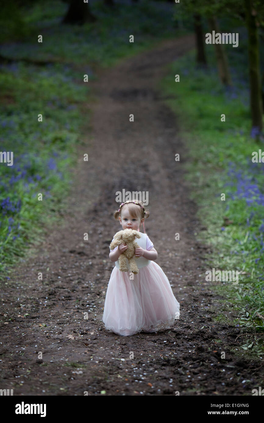 Little girl walking along a woodland path in Spring Stock Photo - Alamy