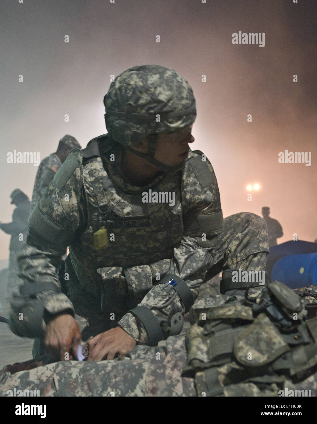 U.S. Army Cpl. Ryan J. Barger, a military police (MP) officer assigned to the 303rd MP Company, evaluates a casualty during 201 Stock Photo