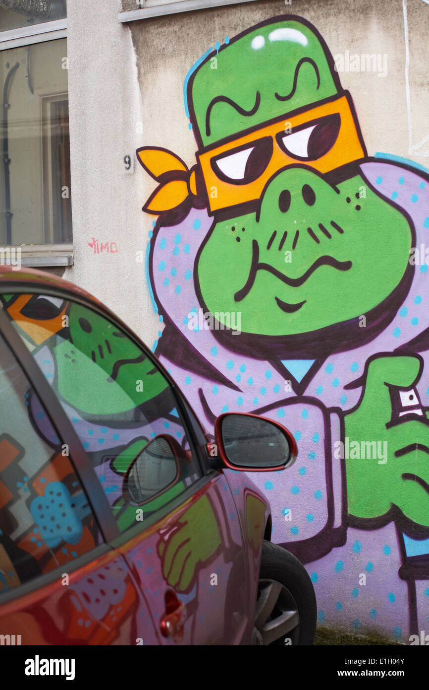green monster street art graffiti reflected in car at Bristol Stock Photo