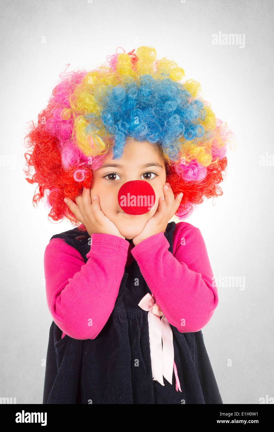Worried little child with red nose and clow wig Stock Photo Alamy
