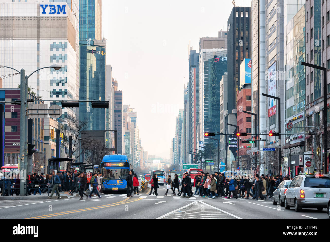 Pedestrians cross the street in the Gangnam district of Seoul, South Korea. Stock Photo