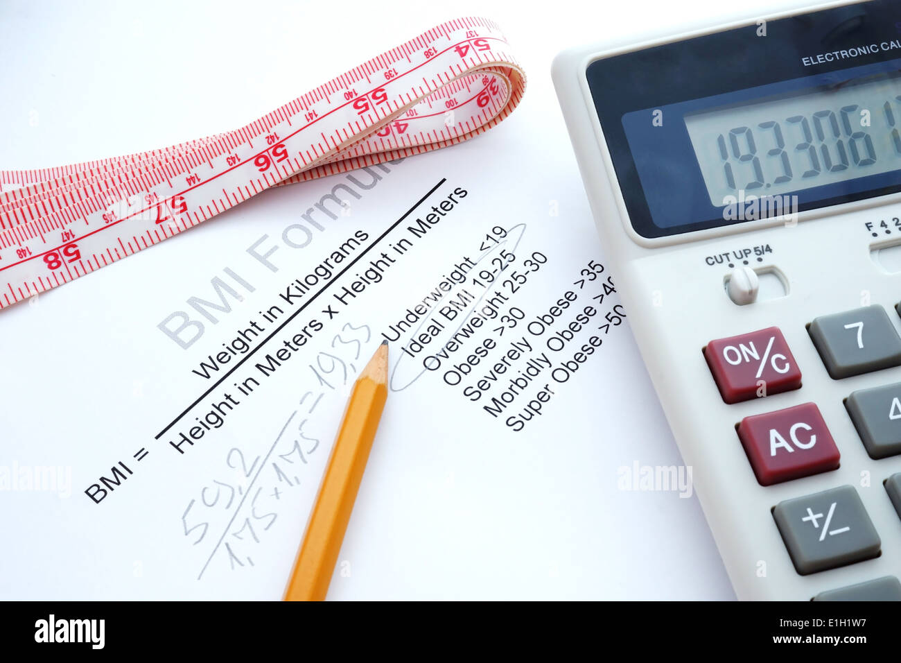 measuring tape, a calculator and a paper with a Body mass index formula Stock Photo