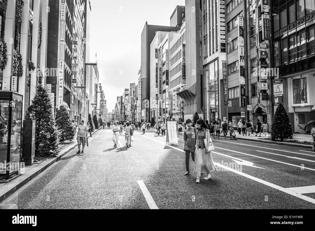 Shoppers wander the streets of Ginza in Tokyo, Japan. Stock Photo