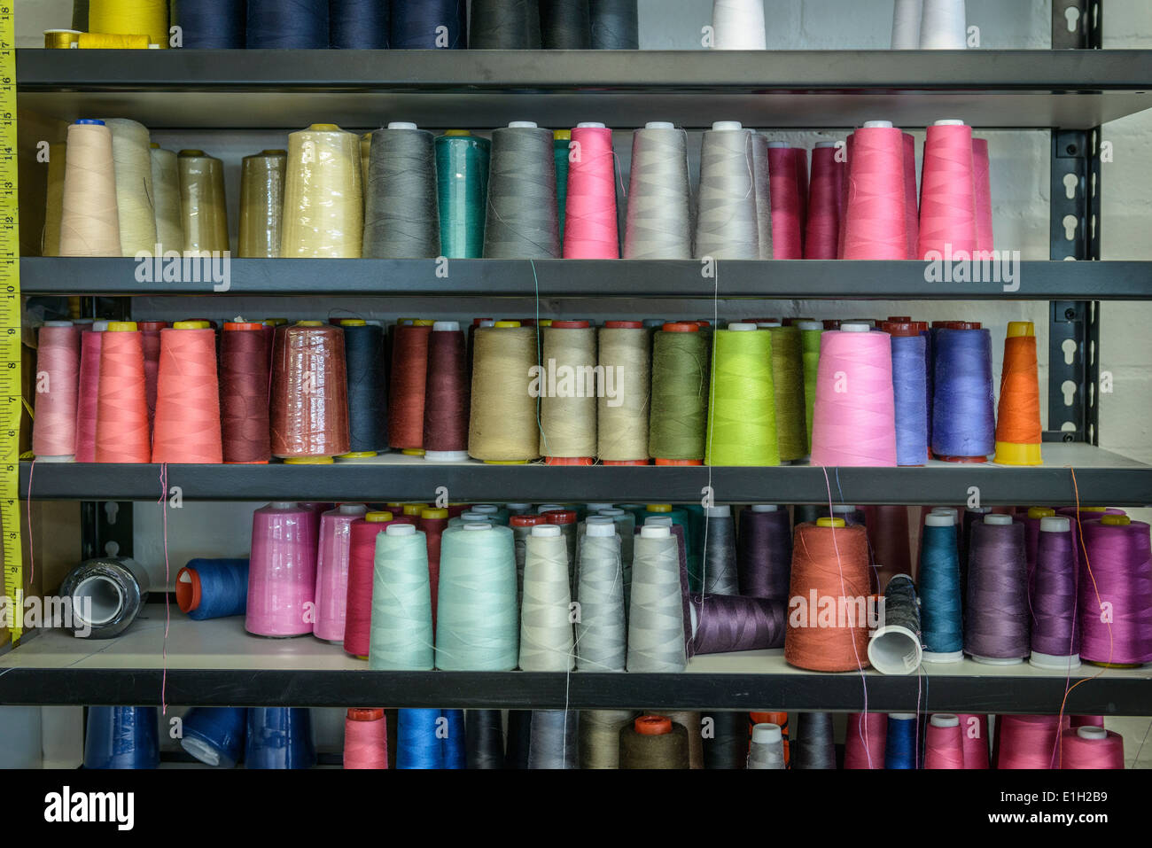 Shelves of coloured threads in fashion studio Stock Photo