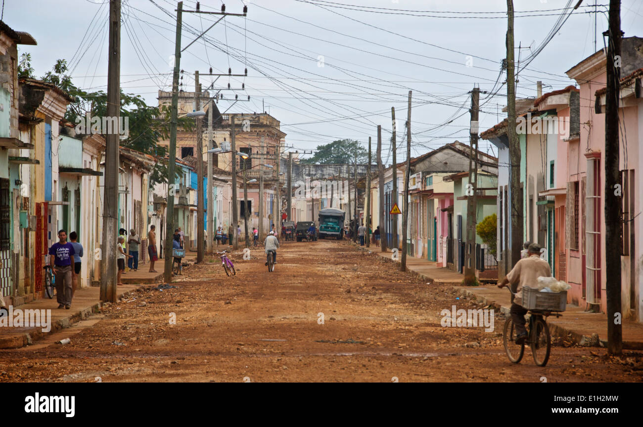 Street, of hard packed earth, in Remedios, Cuba showing a jumble of power and telephone wires Stock Photo