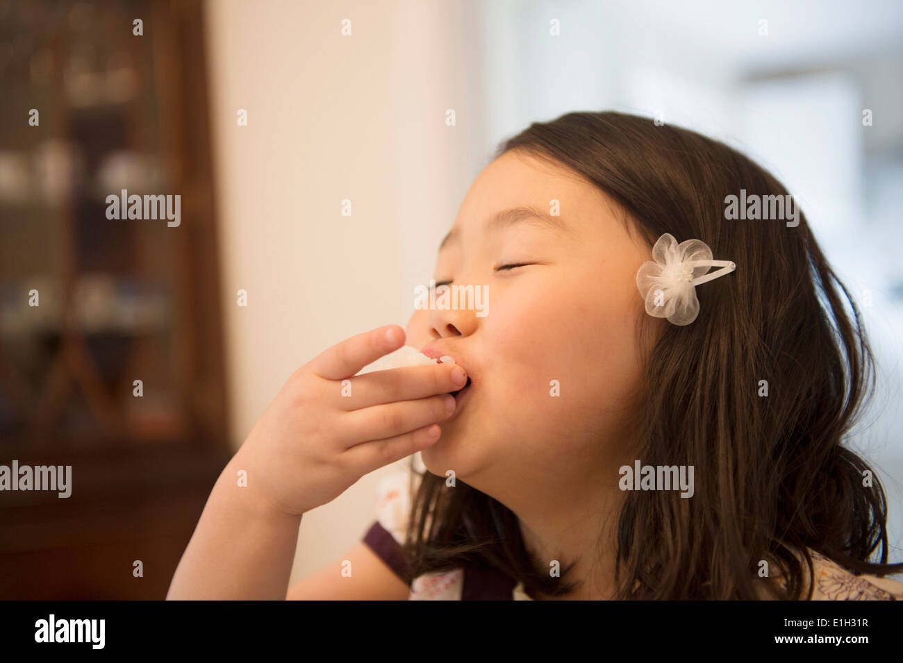 Young girl enjoying a snack Stock Photo