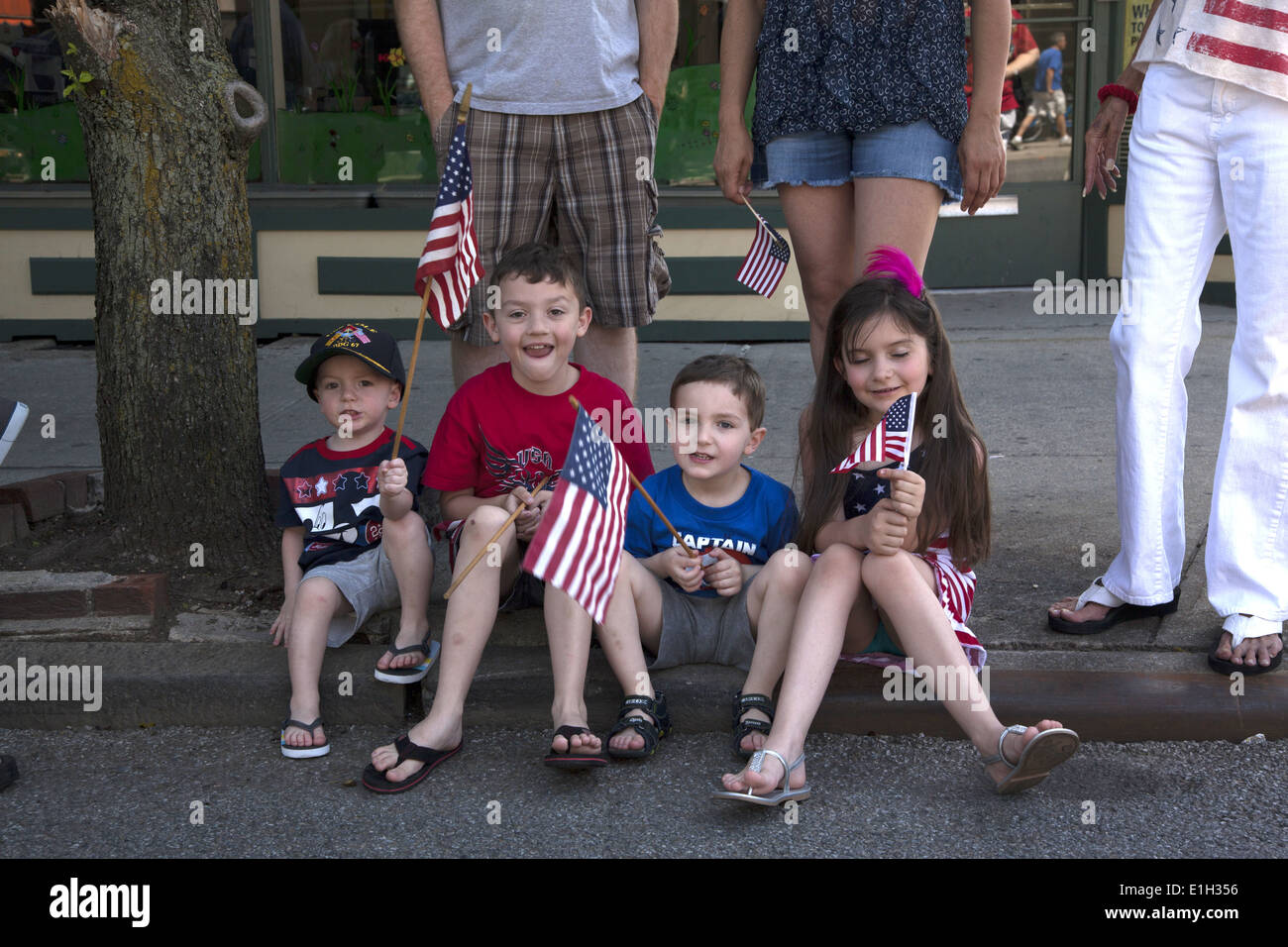 Young children watch the Memorial Day Parade with flags in hand in Bay Ridge, Brooklyn, NY Stock