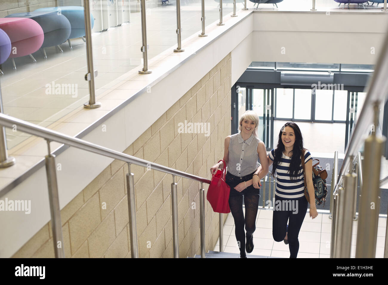 Young women walking up staircase Stock Photo