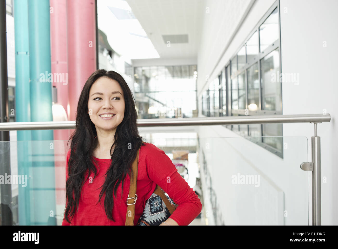 Young woman with long black hair smiling, portrait Stock Photo
