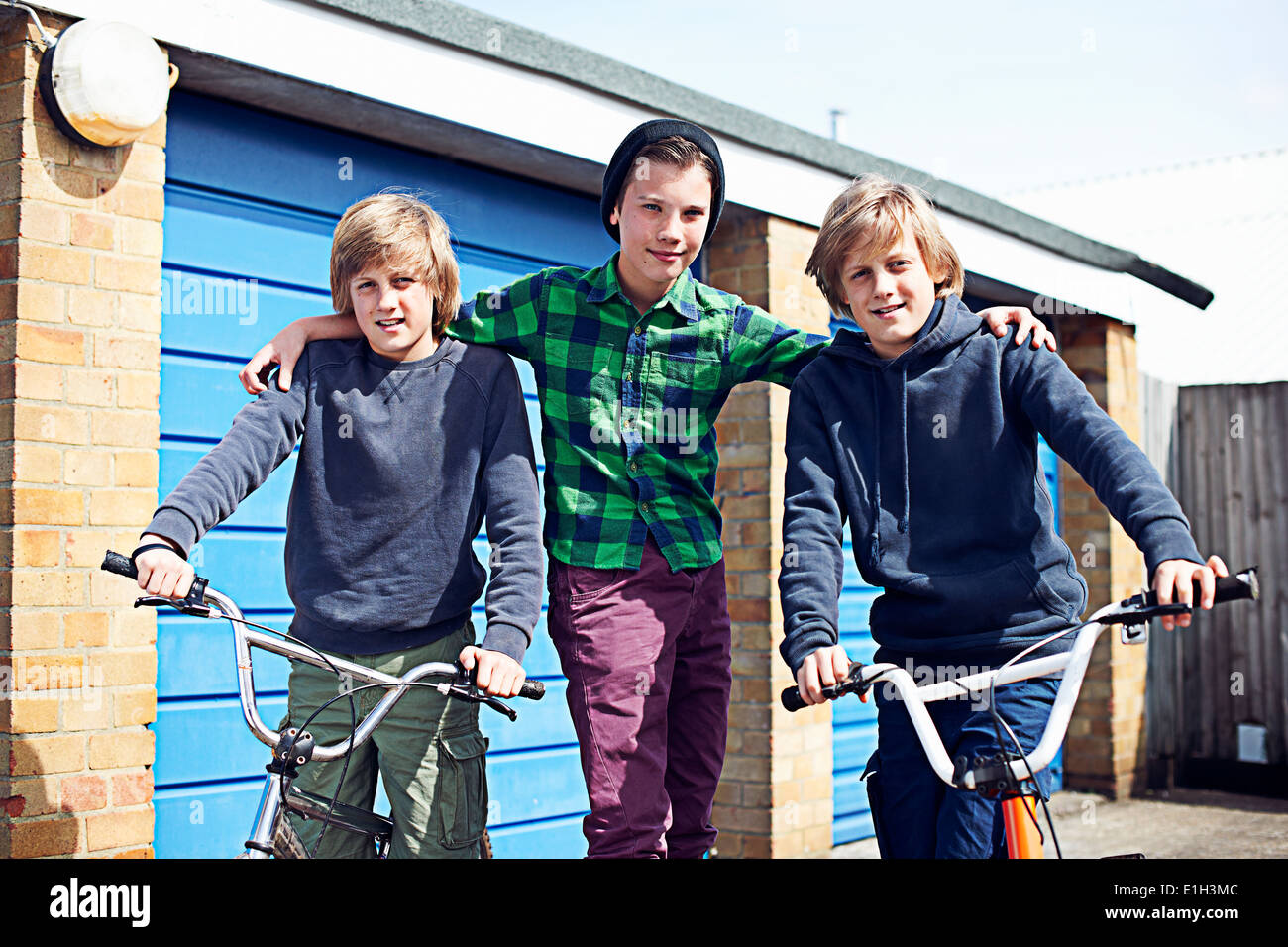 Portrait of three boys with bikes Stock Photo