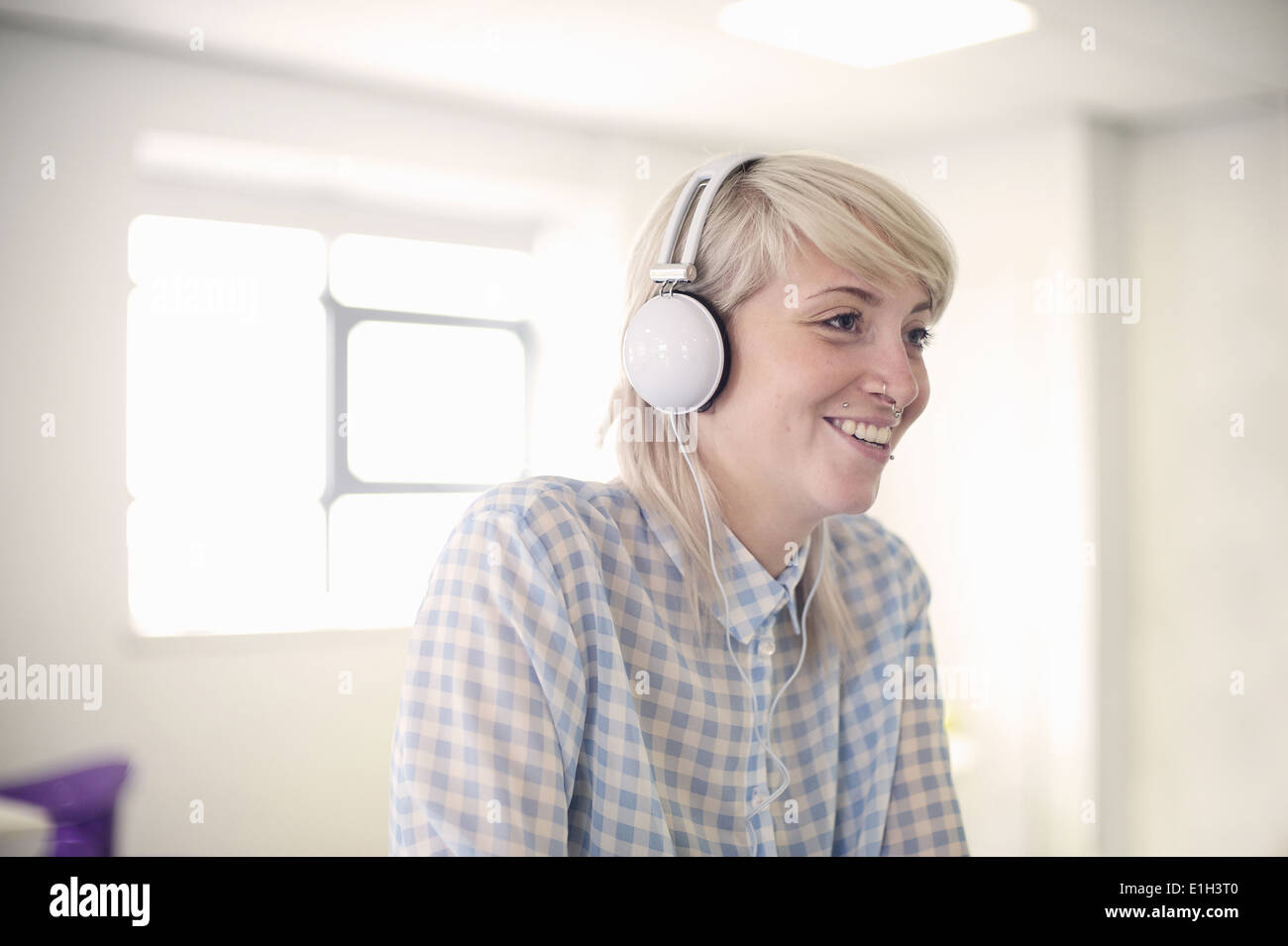 Young woman listening to headphones Stock Photo