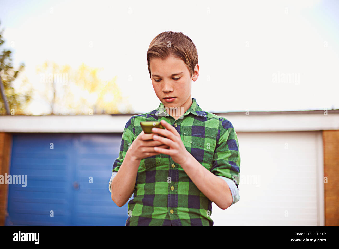 Boy using cell phone Stock Photo