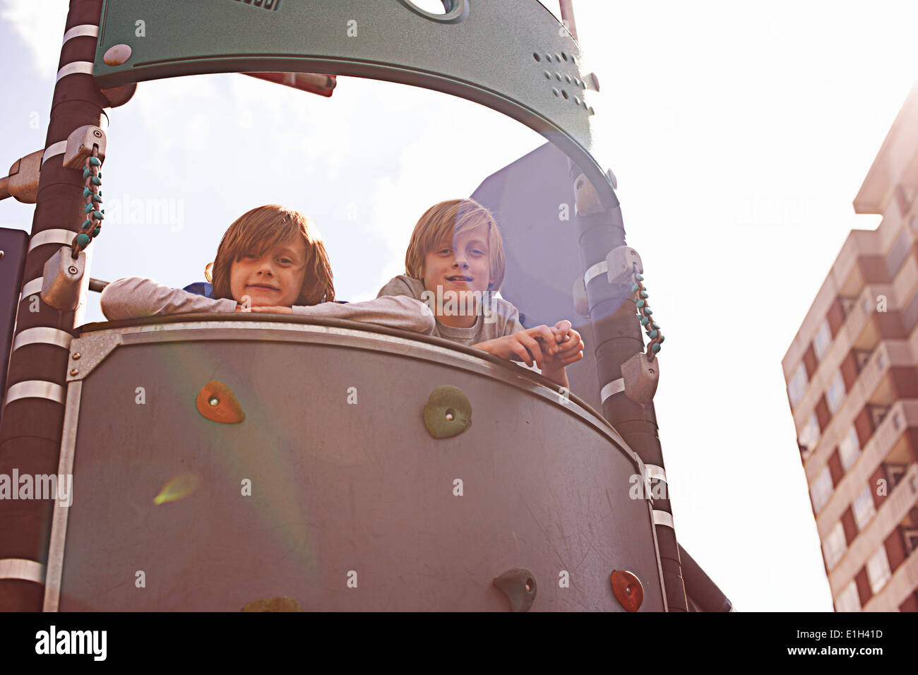 Two boys on climbing frame Stock Photo