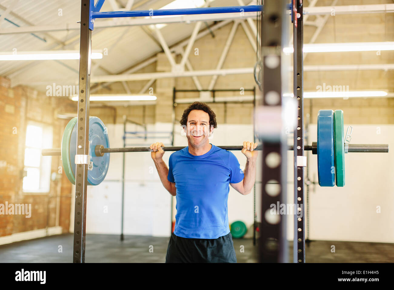 Man lifting barbell in gym Stock Photo