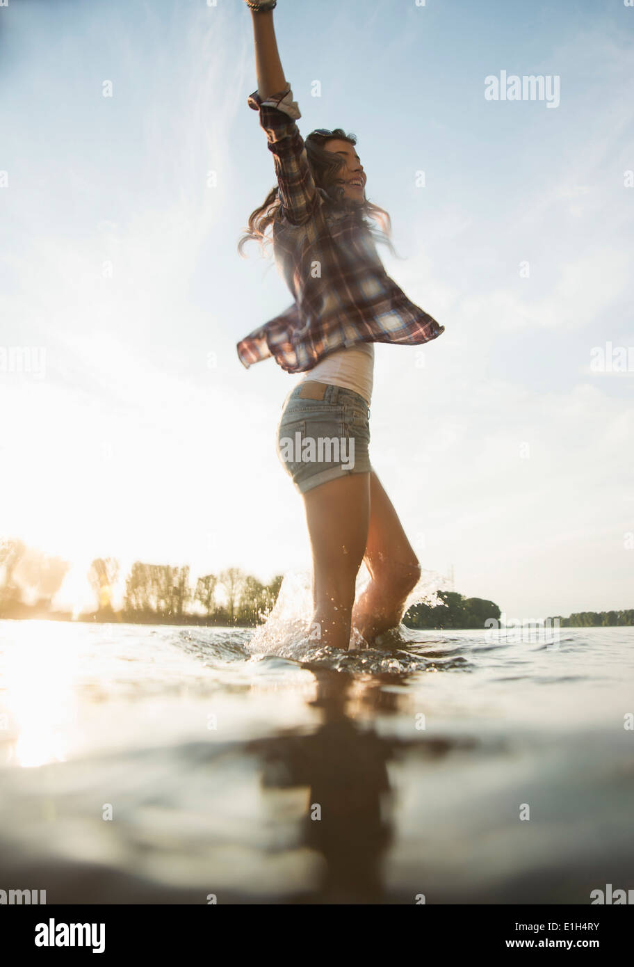 Young woman paddling in lake Stock Photo