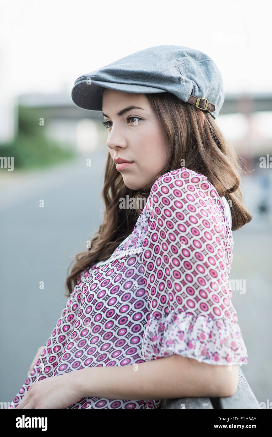Young woman wearing flat cap Stock Photo