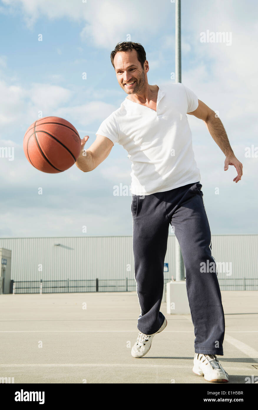 Basketball player dribbling basketball Stock Photo Alamy
