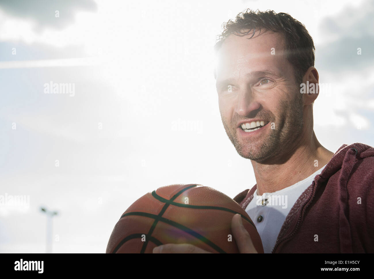 Basketball player holding basketball Stock Photo