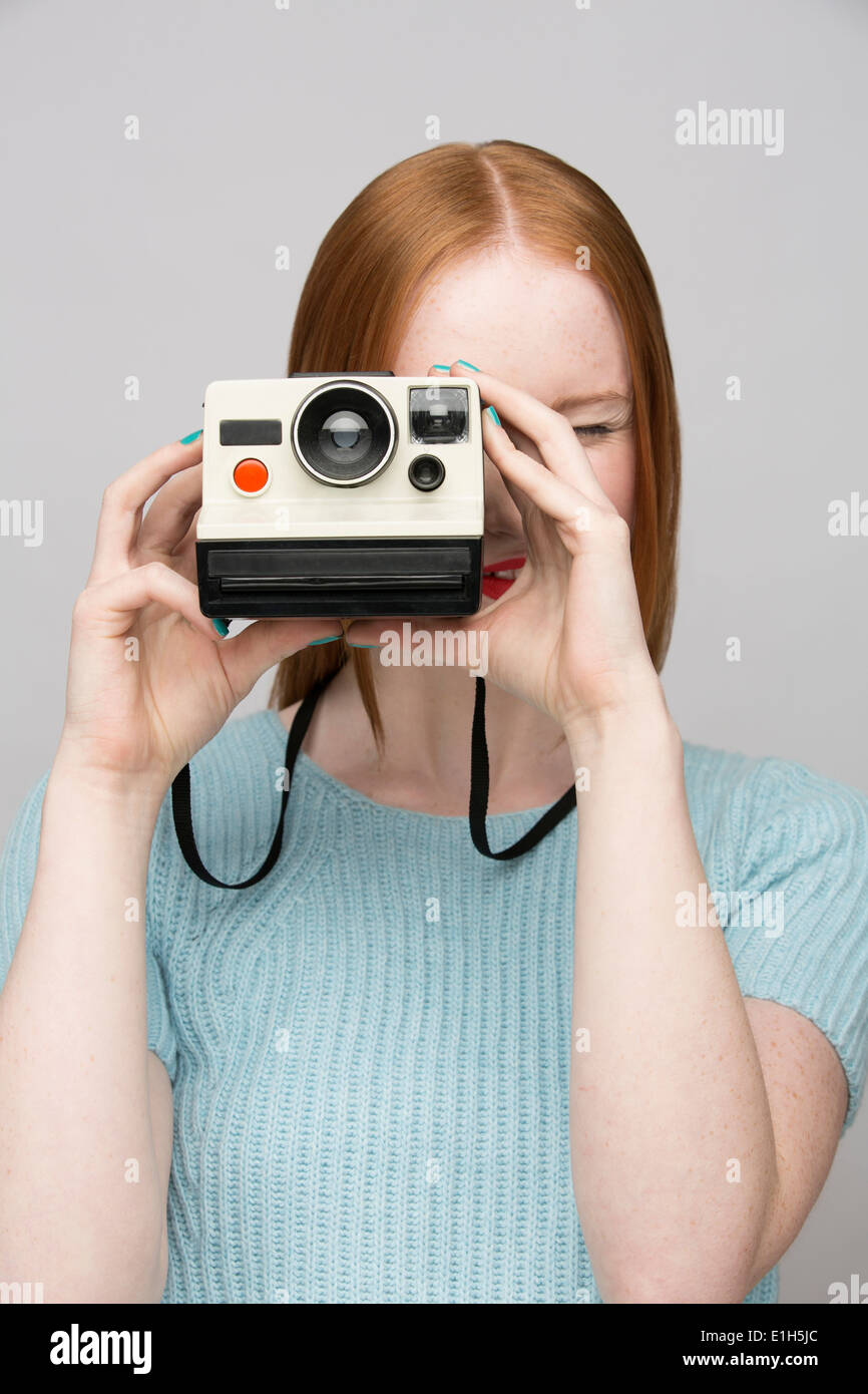 Young woman with polaroid camera Stock Photo - Alamy