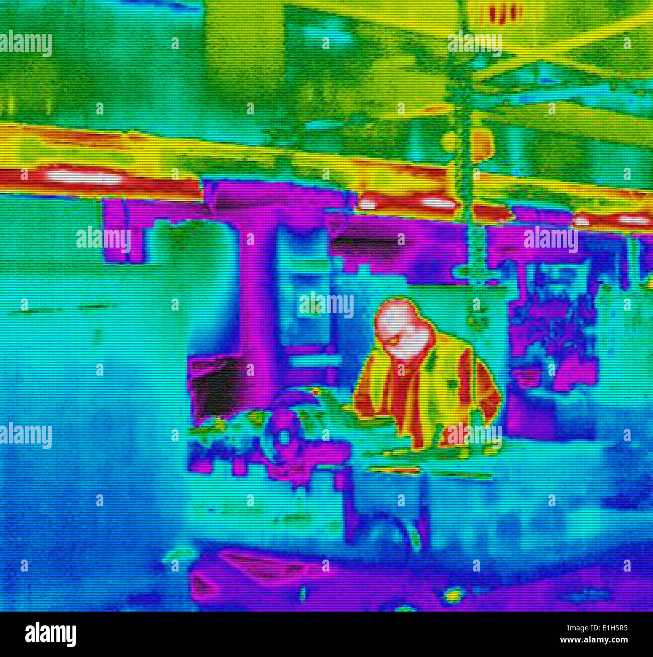 Infra red heat image of worker and heat loss in factory Stock Photo