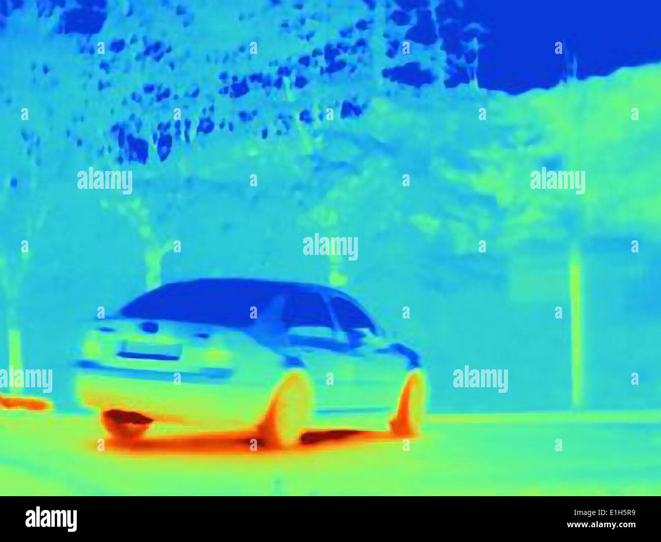 Thermal image which reveals the heat of the tyres and exhaust of a speeding car Stock Photo