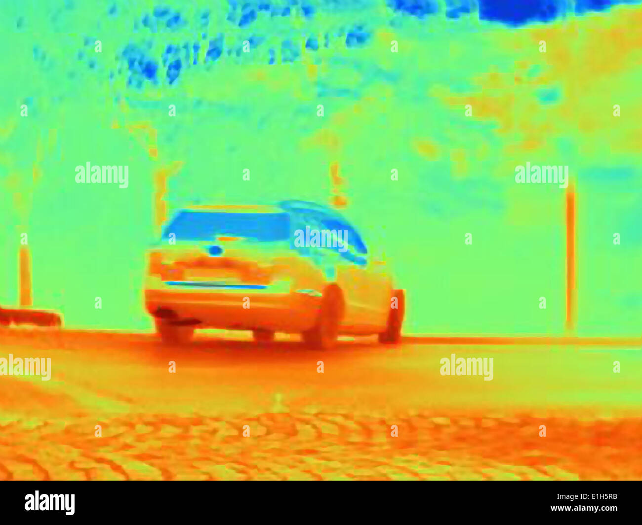 Thermal image revealing the heat of the tyres and exhaust of a speeding car Stock Photo