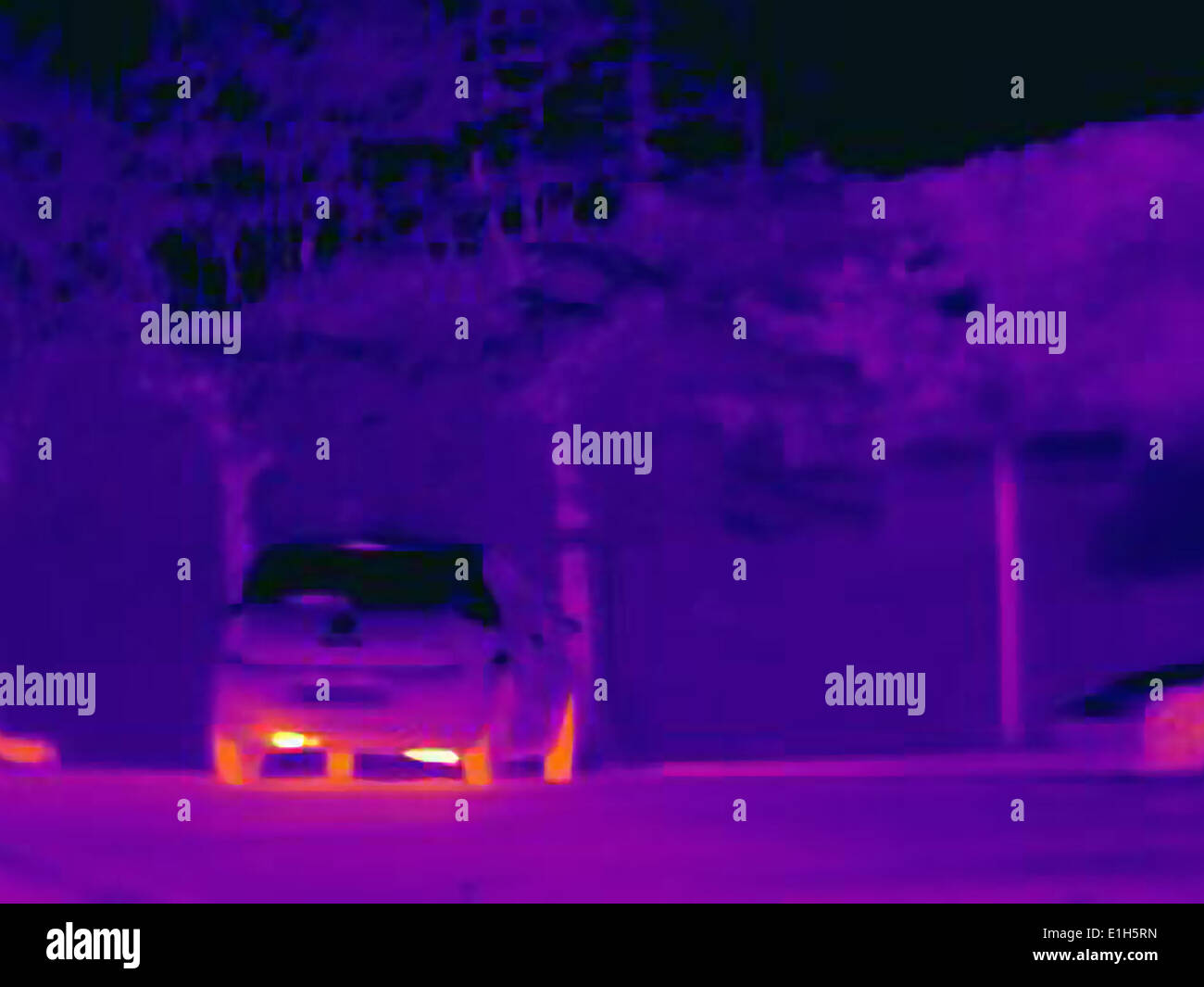 Thermal image revealing the heat of the exhaust and tyres of a speeding car Stock Photo