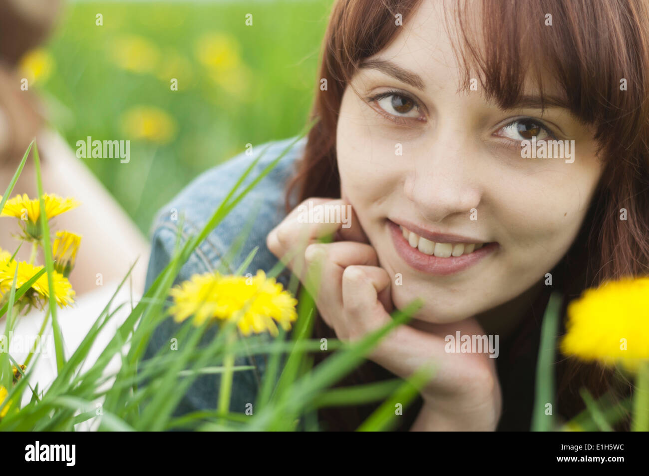 Close up portrait of young woman with dandelions Stock Photo