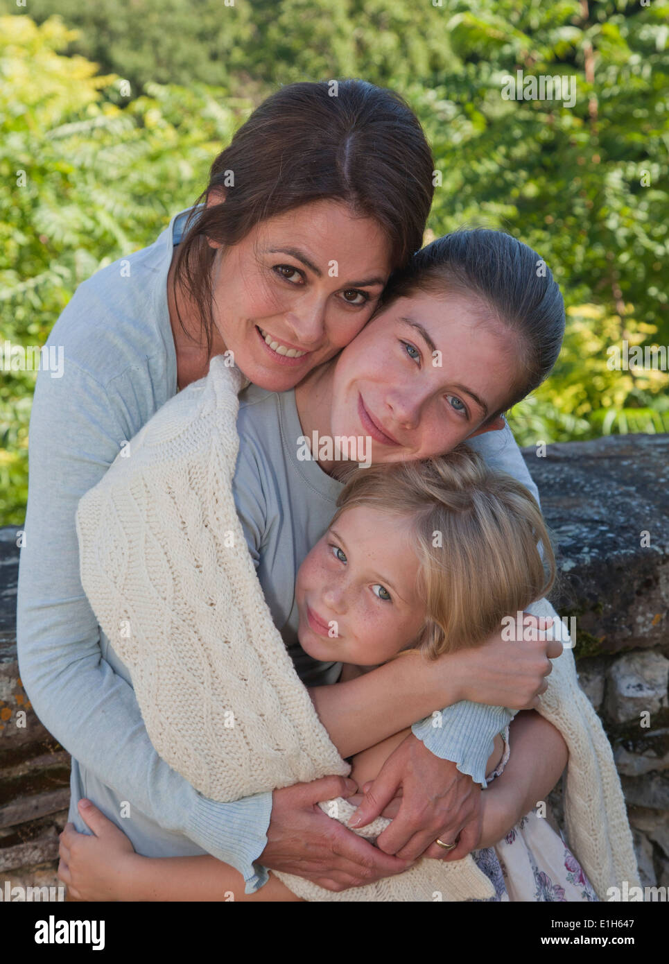 Mother hugging daughters hi-res stock photography and images - Alamy