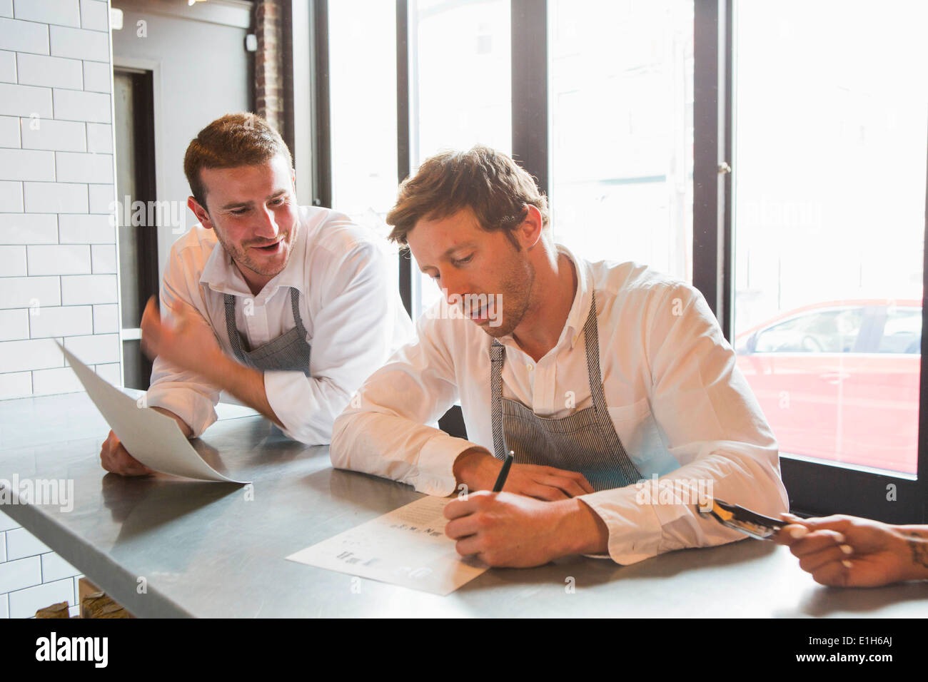 Chefs preparing for service in restaurant Stock Photo